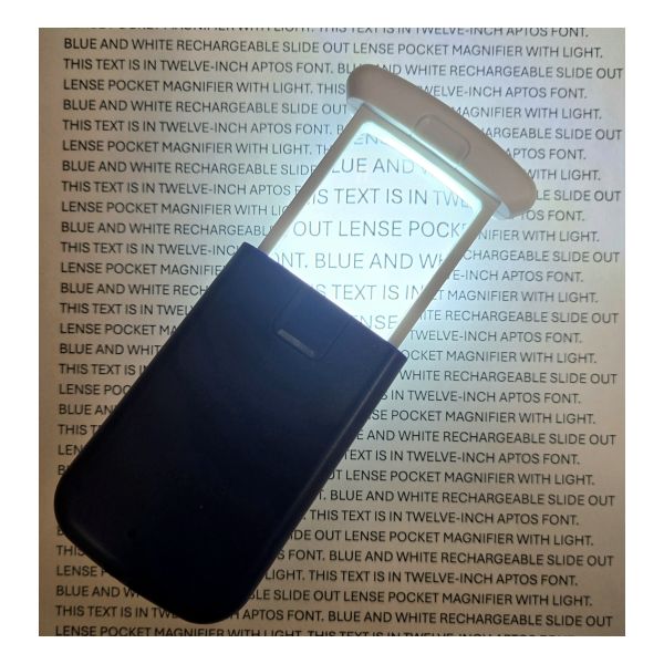 LED-illuminated magnifier sits open on a page of text demonstrating its magnifying capacity when lit.