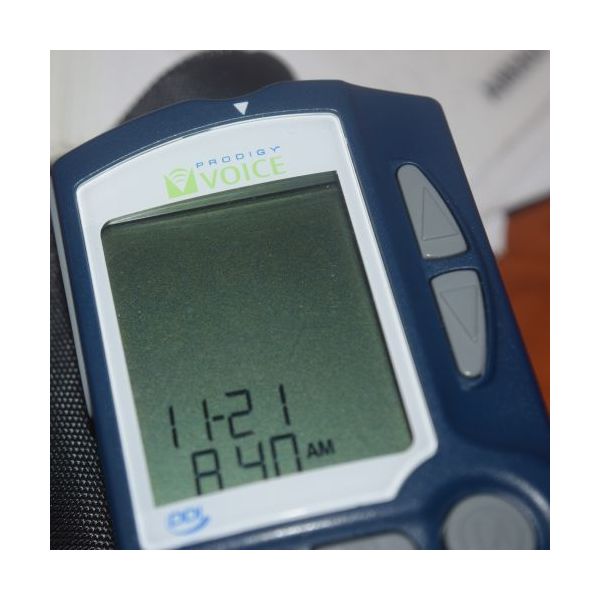 Close up of Prodigy glucose monitor showing the LCD screen and up/down buttons.
