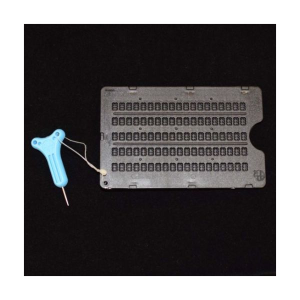 A five-line slate with 19 cells per line; a plastic blue saddle stylus is also pictured.