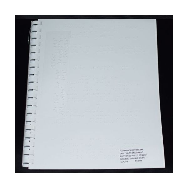 A Braille book bound with a white plastic comb.