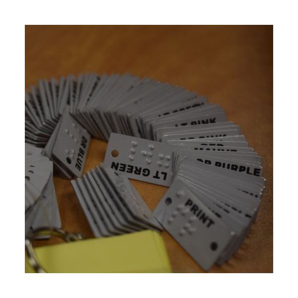 Gray aluminum color labels marked in Braille and print.